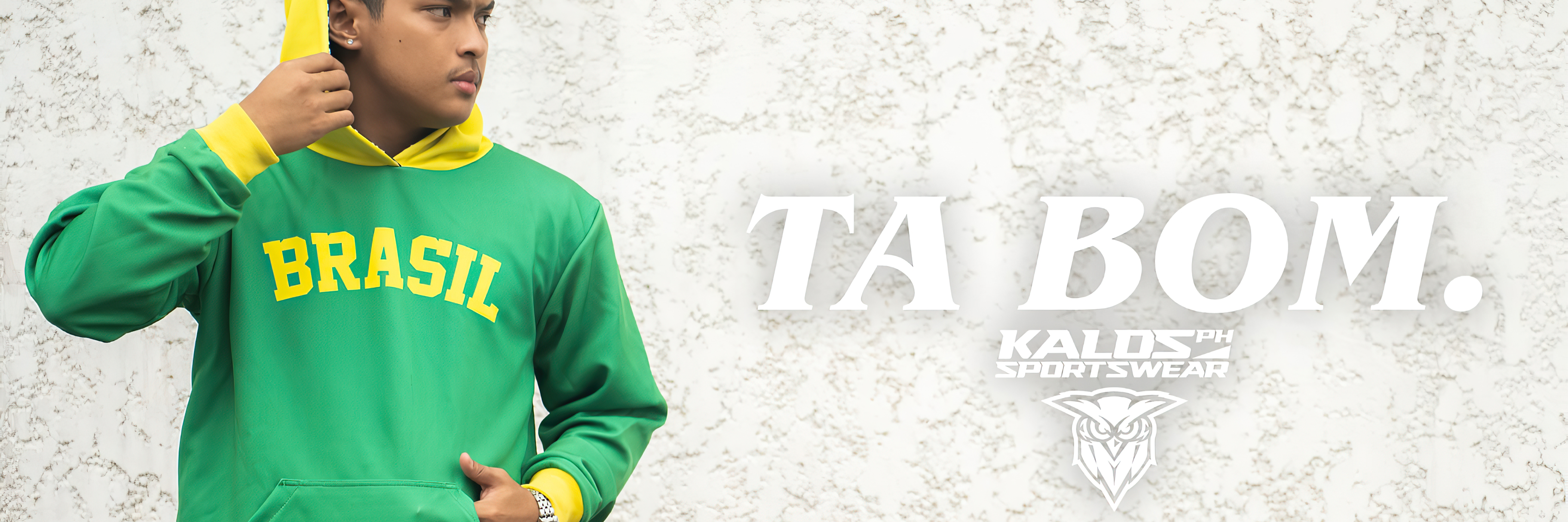 A person wearing a green and yellow "BRASIL" custom hoodie, showcasing Kalosph Sportswear's custom apparel design capabilities for clients in Marikina, Calabarzon, Philippines